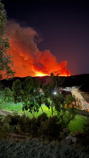 Wildfire approaching Milken Community Schools at night, viewed across the campus