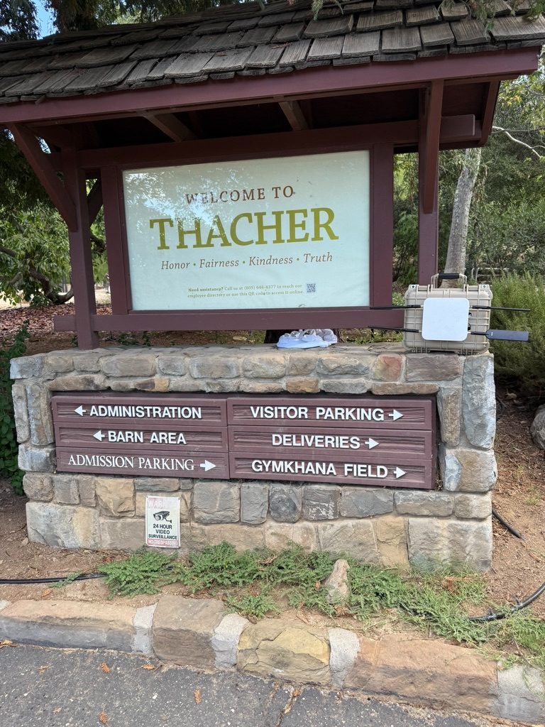 A weatherproof Bright5G unit mounted beside the Welcome to Thacher entrance sign