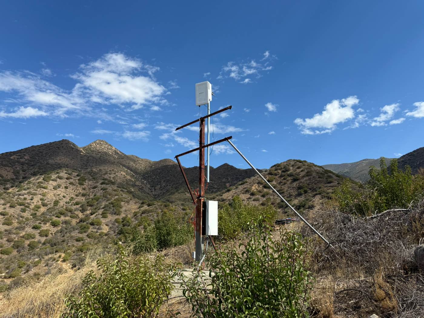 The Bright5G radio mounted on a mast high on a ridge above the Thacher campus, with the Ojai mountains behind it